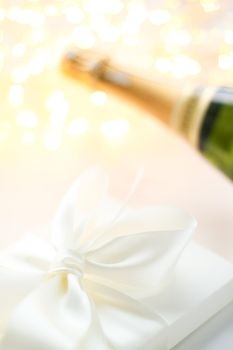 Romantic celebration, lifestyle and luxury present concept - The bottle of champagne and holiday gift box