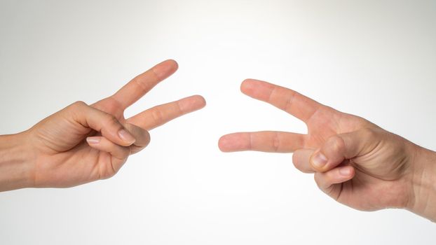 Hands close-up gesture from the game rock paper scissors. High quality photo