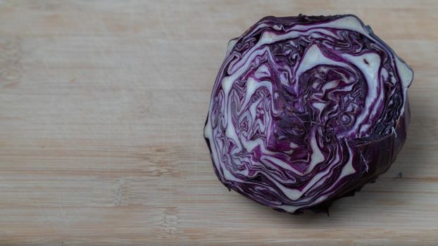 Head of purple cabbage Kohlrabi in a cut on a wooden background - vegetables. High quality photo