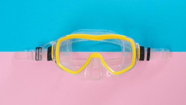 Yellow snorkeling mask on a two-tone background. High quality photo