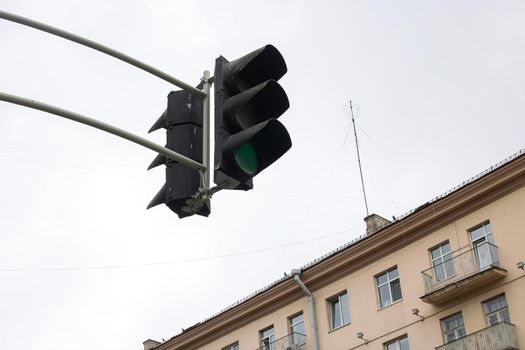 Traffic light against a gray sky close up