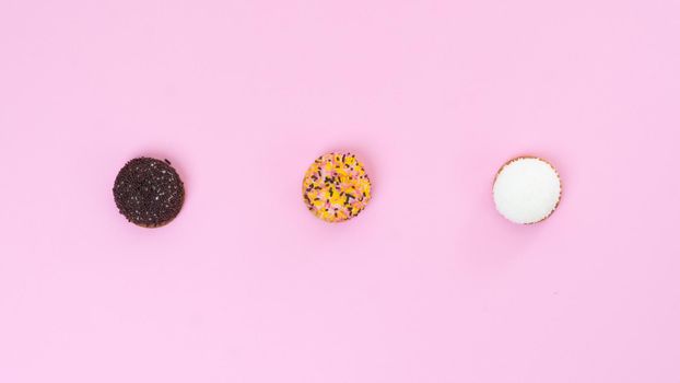 Three cakes on a pink background. High quality photo