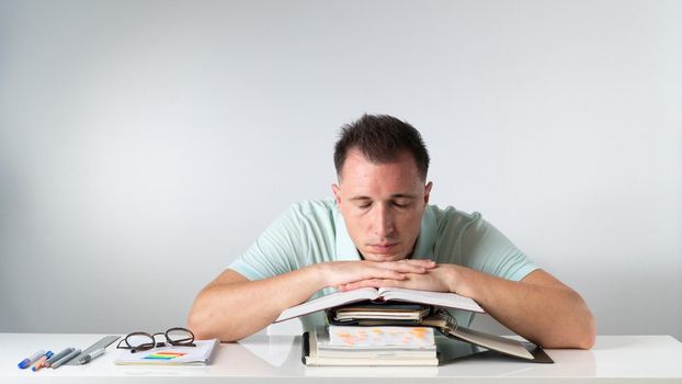 Student sleeps on books and notebooks - exams, studies, admission. High quality photo