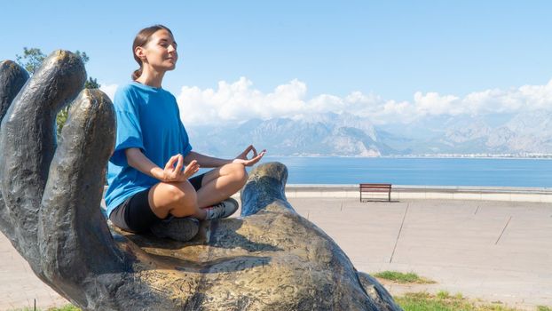 Meditation in nature against the backdrop of mountains and sea. High quality photo