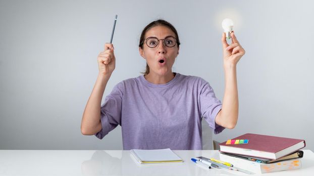 A student teaches lessons, an idea and an answer come, a light bulb is on. High quality photo