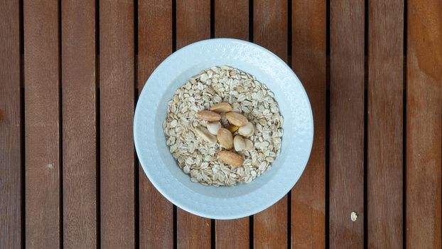 Oatmeal with nuts in a breakfast cup flat