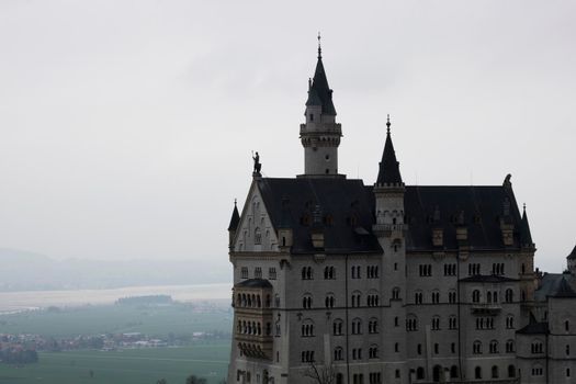 Neuschwanstein tourist Castle in Germany surrounded by the fog