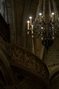 Interior view of a church showing a lamp and a balcony in the background