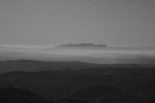 Montserrat mountain surrounded by mist in a minimalistic landscape picture