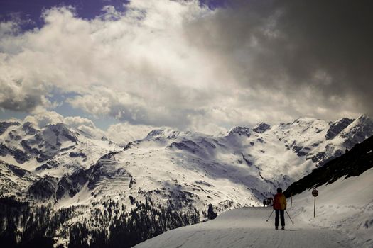 Snowy mountains and a skier in a ski station in Bad Gastein in Austria