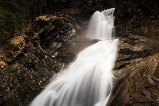 Beautiful landscape showing Krimmler waterfall in a rocky mountain in Austria in long exposure picture