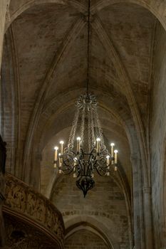 Interior view of a church showing a lamp and a balcony in the background