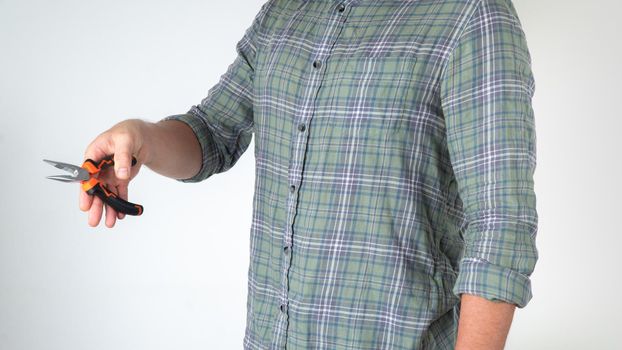 Eletkrik with piles in his hands - a gesture of how to bite a wire on a white background. High quality photo