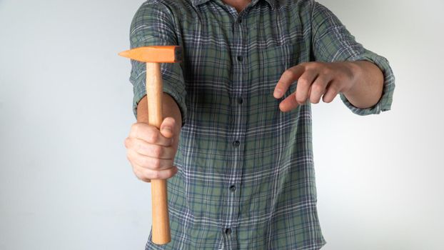 A man holds a hammer in his hand - home repairs. High quality photo