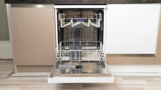 Open empty dishwasher with extended bottom shelf. High quality photo