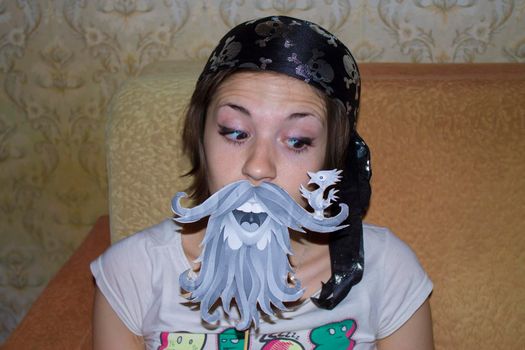 Girl in pirate costume, with a painted beard, costume party. High quality photo