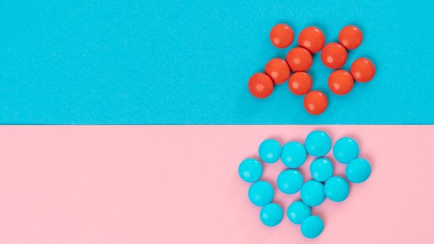 Blue and red candies on a two-tone background - bright collage. High quality photo