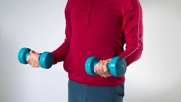 Man with dumbbells - sports training, pump muscles. High quality photo