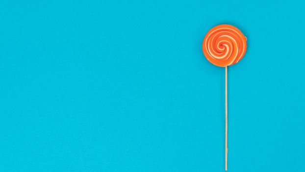Lollipop on a blue background with text space. High quality photo