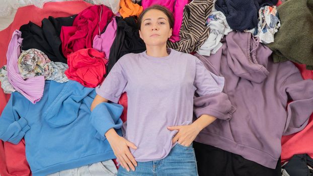 Shopaholic, women's wardrobe - a woman in a pile of clothes, nothing to wear. High quality photo