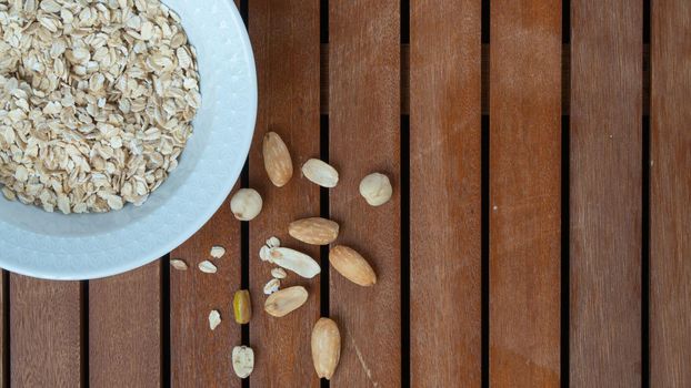 Oatmeal in a cup and nuts breakfast space for text. High quality photo