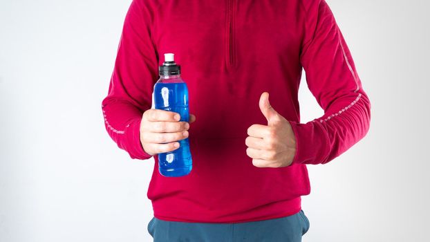 Athlete with sports drink, electrolyte, shows class on white background. High quality photo