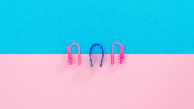 Swimming kit - nose clip, earplugs in the ears, color composition. High quality photo