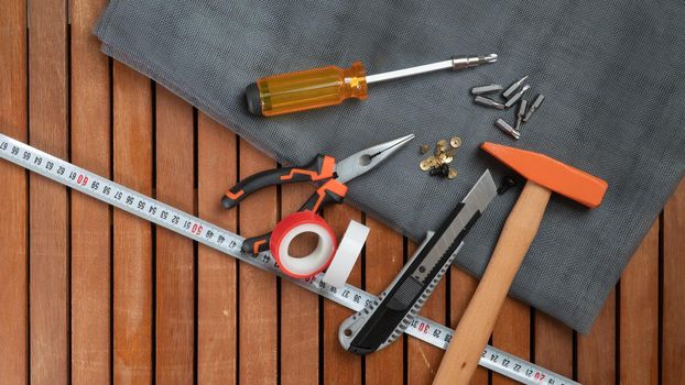 Tool kit on wooden background screwdriver, hammer, wire cutters. High quality photo