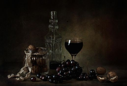 still life of berries and fruits on the table on a dark background photo