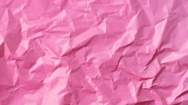 Wrinkled colored paper background texture voluminous pink. High quality photo