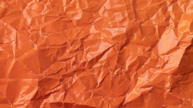 Wrinkled colored paper background texture voluminous orange. High quality photo