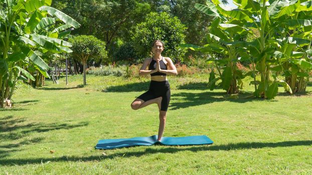 Yoga poses, balance on one leg, a woman doing yoga in nature. High quality photo