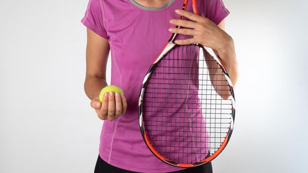 Sporty woman with tennis racket and ball on a white background. High quality photo