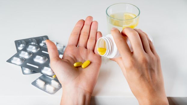 A sick person pours pills from a jar medicine treatment. High quality photo