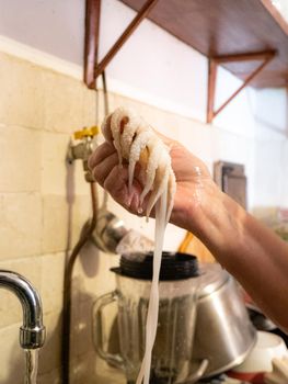 cleaning a raw adriatic cuttlefish at home in Numana, Marche, Italy