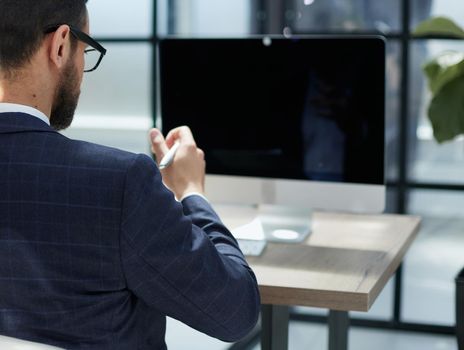 Modern Office Businessman or Manager Working on Computer, Smiling, Looking at Camera.