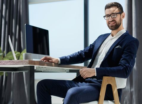 Head shot portrait of happy young handsome confident man in eyeglasses