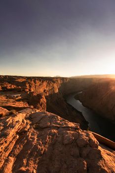 Golden hour view of Colorado river crossing a canyon in Page in Arizona USA