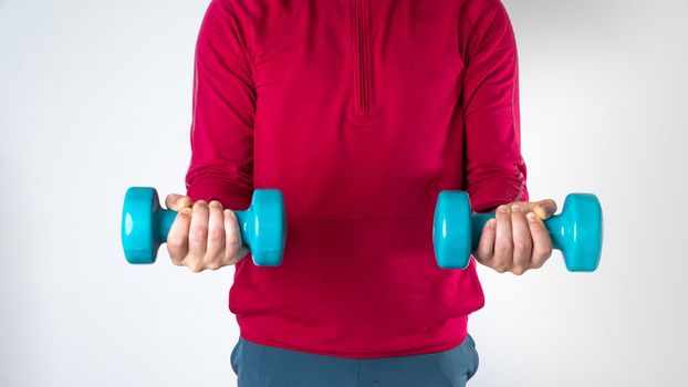 Athletic man with dumbbells in his hands for training. High quality photo