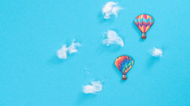 Flight of balloons in the clouds, blue background with space for text. High quality photo