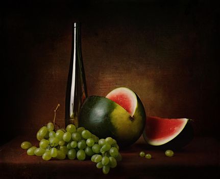 still life of berries and fruits on the table on a dark background photo