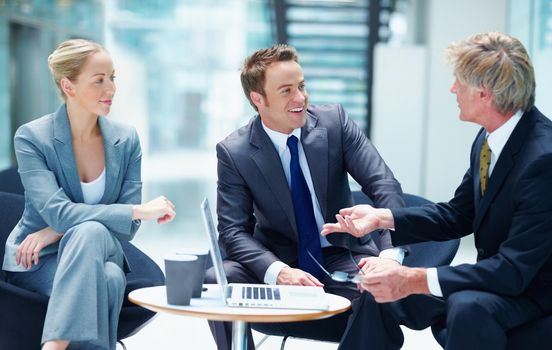 Business people speaking with laptop. Portrait of successful business people speaking with laptop in office