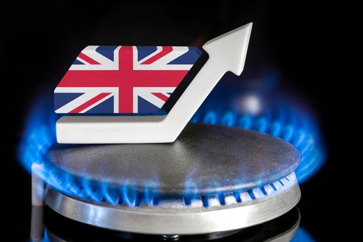 Gas price. Rise in gas prices in United Kingdom. A burner with a flame and an arrow up, painted in the colors of the United Kingdom flag. The concept of rising gas or energy prices