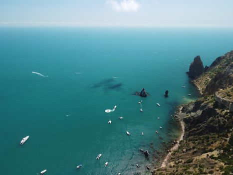 Aerial boat race. Luxury cruise trip. View from above of white boat on deep blue water. Aerial view of rich yacht sailing sea. Motor boat racing wave. Summer journey on luxury ship