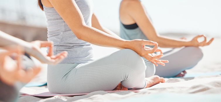 Women meditation in lotus with zen yoga class at the beach. Group of wellness female together on mat, leg crossed, finding inner mental balance and peace. Practice calming breathing exercise.