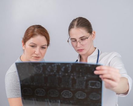 Female doctor explaining mri of internal organs to female patient