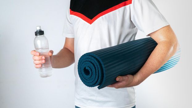 Man with Yoga Mat and Water Bottle - Sporty Lifestyle. High quality photo