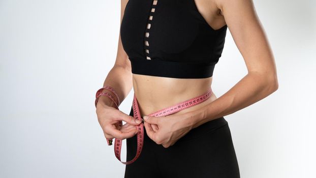 Female Athletic Figure - Measure Waist with Measuring Tape. High quality photo