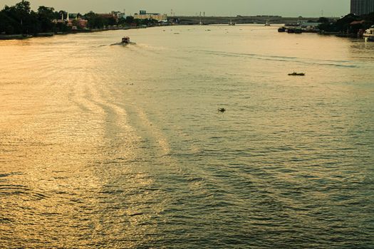 panorama nature landscape of long tail boat riding against sunset on River in Bangkok Thailand