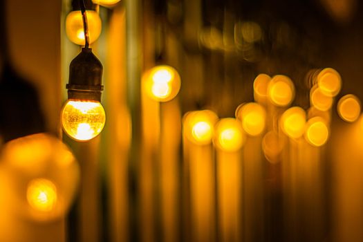 Decor Hanging Yellow Orange Light Lamp With Blurred lamp light Dark Night Background